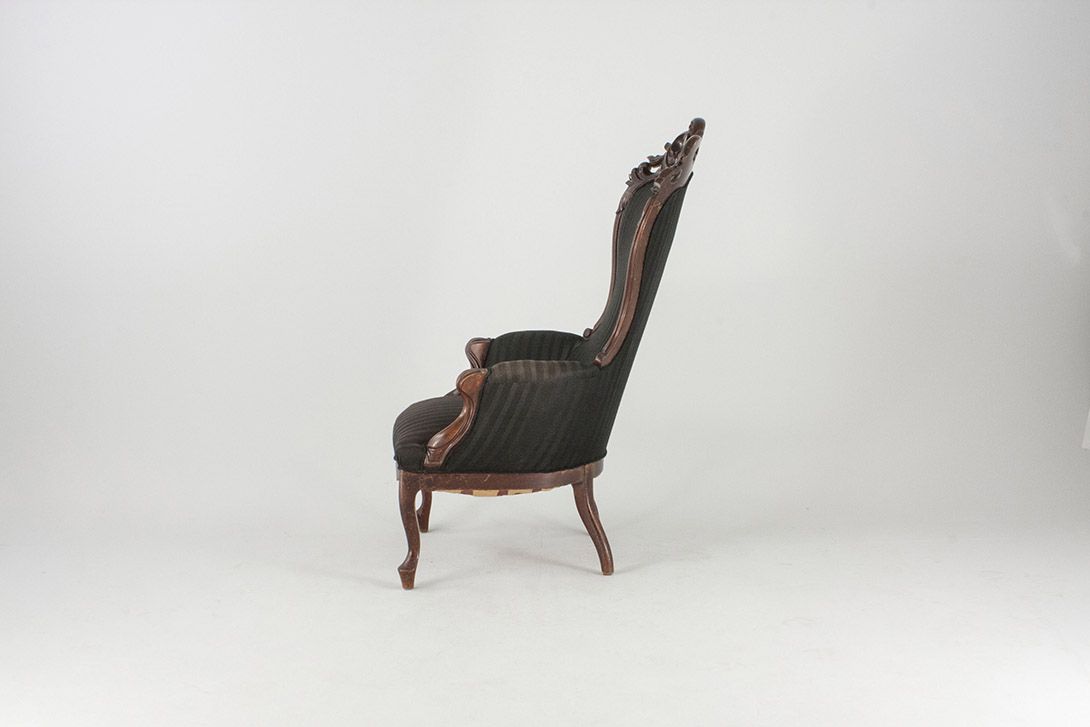 Foto Antique Armchair with Carved Back Detail and Black Upholstery
